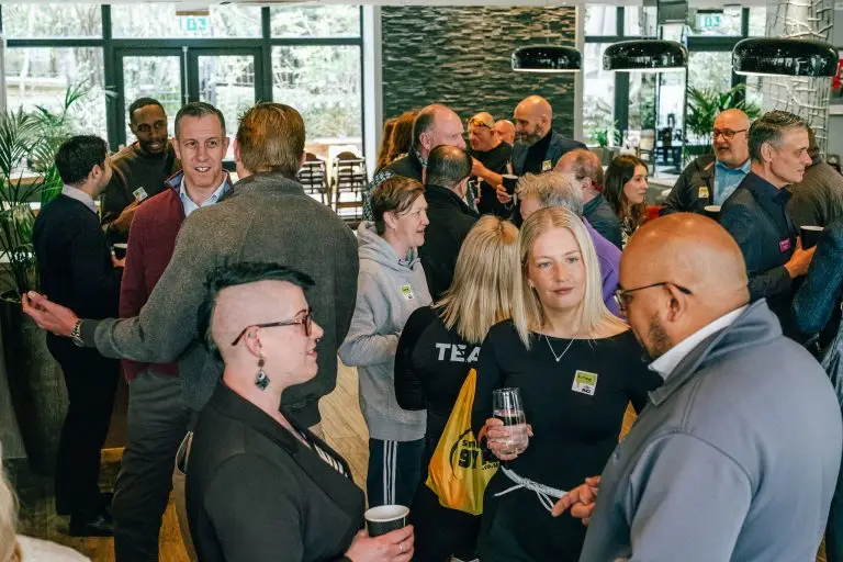 crowd of people at networking event chatting to each other