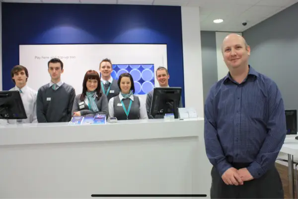 Mark Jones standing in front of the staff at O2 Wellingborough on the opening day of the new bigger store.