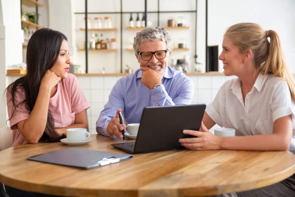 Happy female manager presenting project on laptop